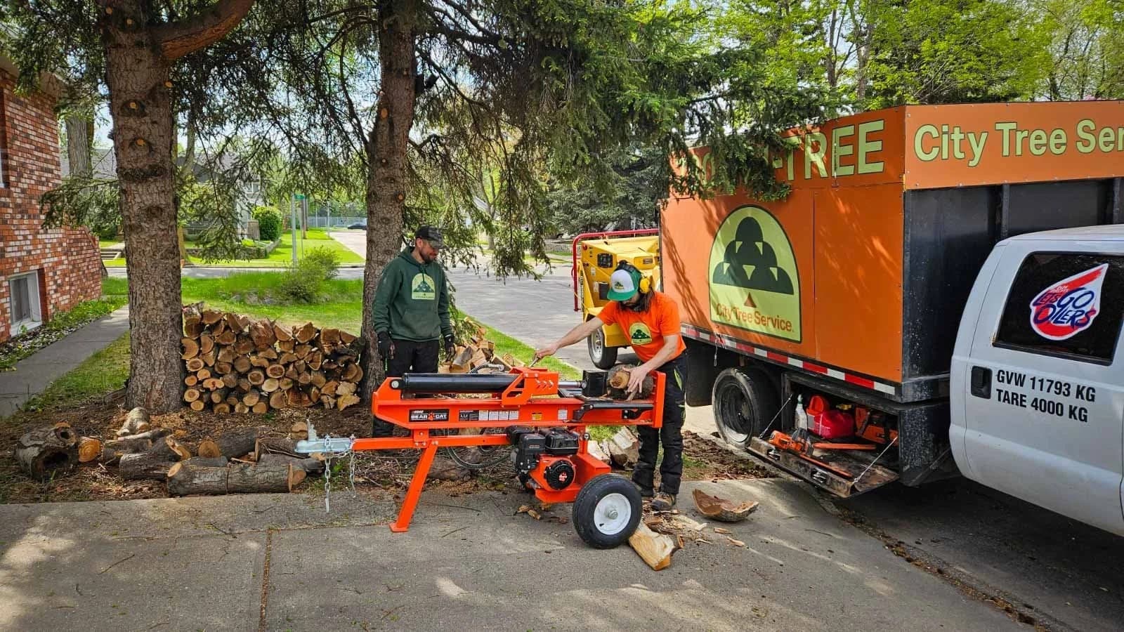Hydraulic wood splitter processing rounds into firewood at an Edmonton residential property